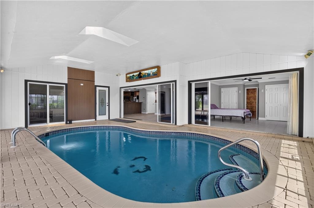 Indoor swimming pool featuring a curved design with integrated steps