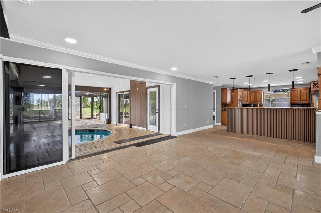 Spacious interior with tile flooring and crown molding