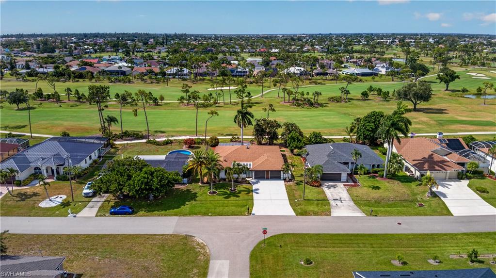 Aerial perspective highlighting residential properties bordering a golf course