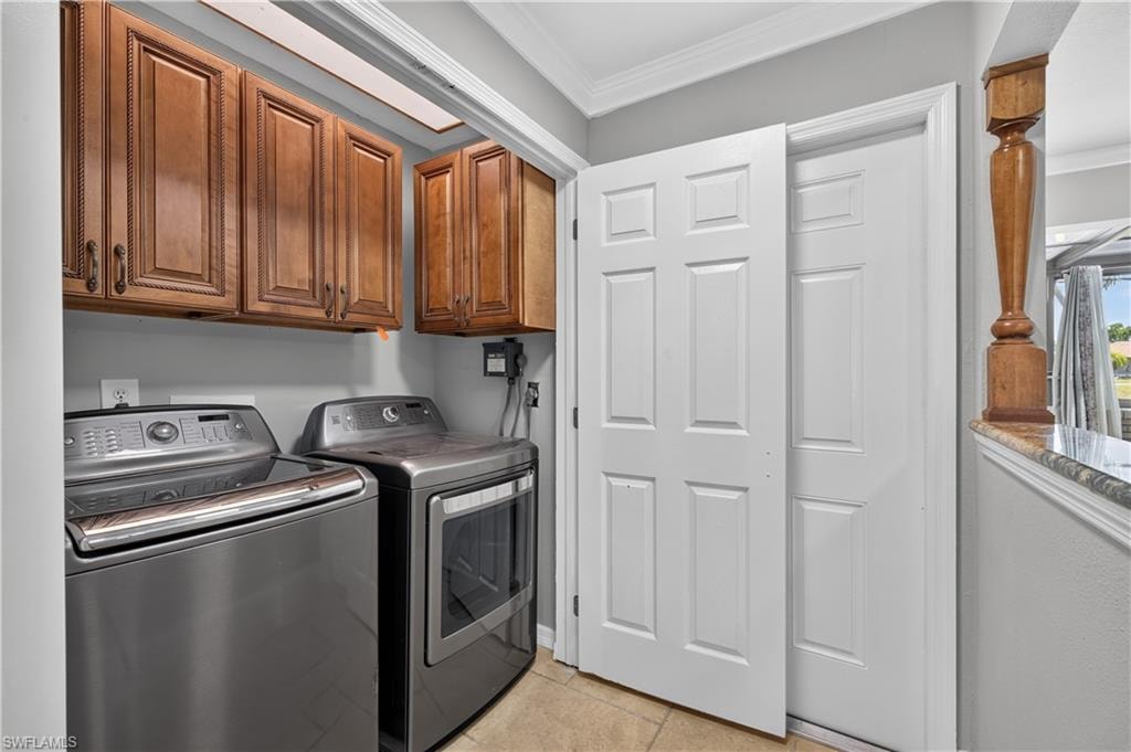 Dedicated laundry area featuring overhead wood cabinetry and tile flooring