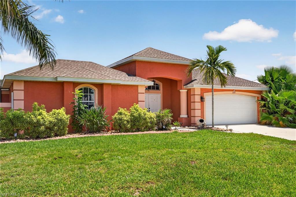 Coral stucco exterior with a hip roof and an arched window