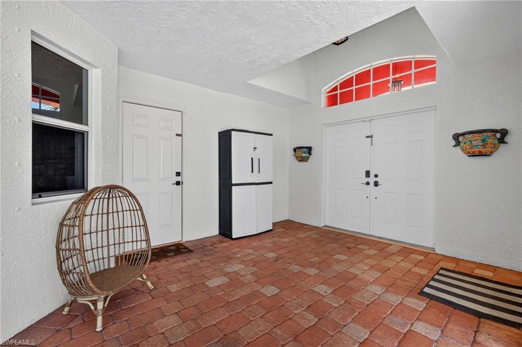 Entryway featuring brick paver flooring and a double-door entry