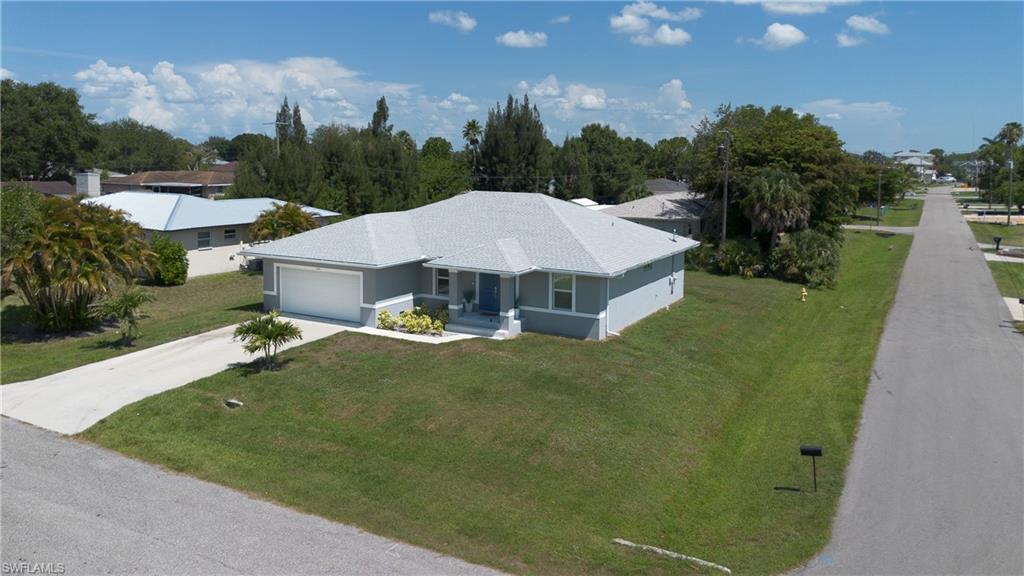 Single-story residence featuring a neutral exterior, attached garage, and concrete driveway