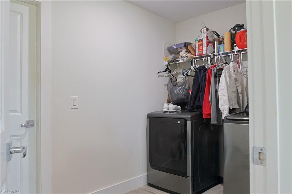 Dedicated laundry area featuring a wire shelf, hanging rod, and light-toned flooring