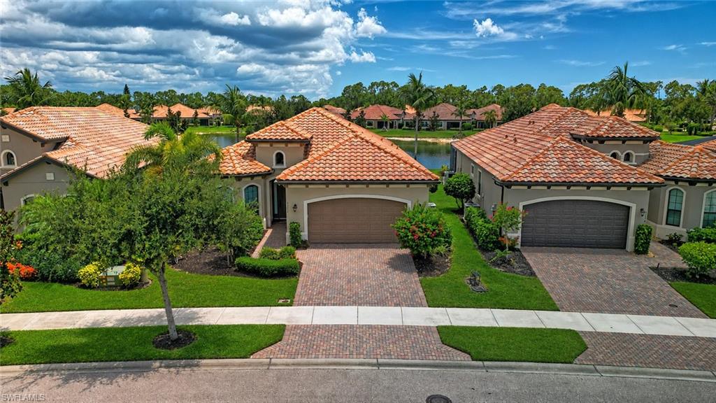 Stunning Bonita Isle water front home with paver driveway, and a two-car garage