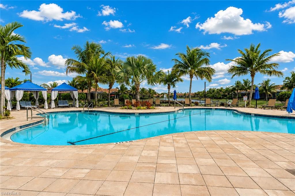 Large resort-style swimming pool with integrated steps and handrails