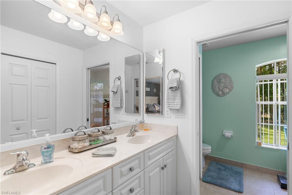 Double vanity with light-toned countertops and under-sink cabinetry