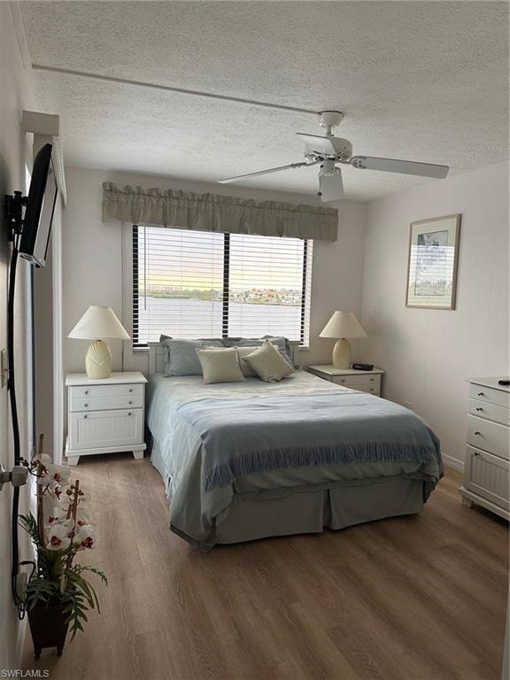 Room with wood-finish flooring and a ceiling fan