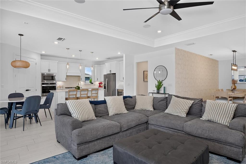 Gather with family and friends in the expansive great room, where the open layout, tray ceiling and abundant natural light create a warm and inviting atmosphere