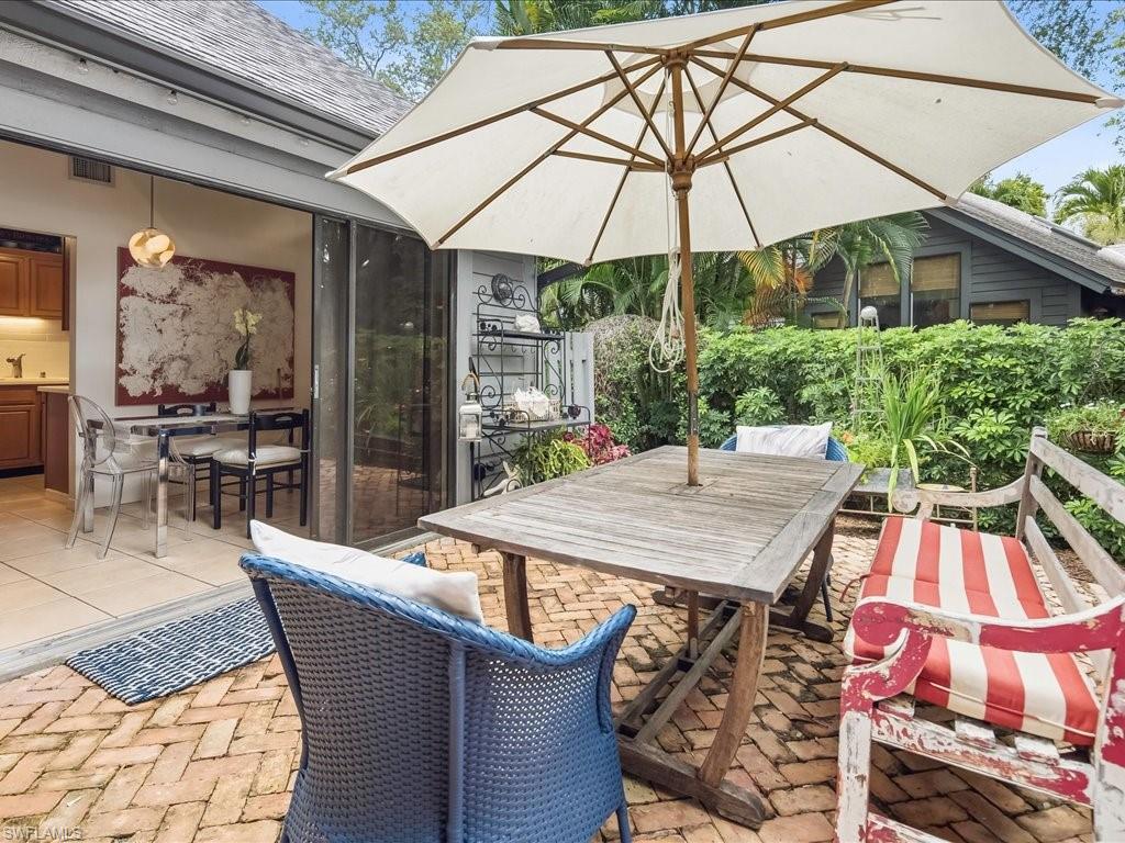 Brick paver patio featuring lush perimeter landscaping