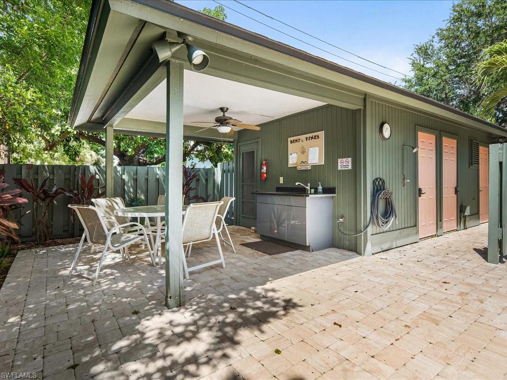 Covered pool patio area featuring a ceiling fan and track lighting