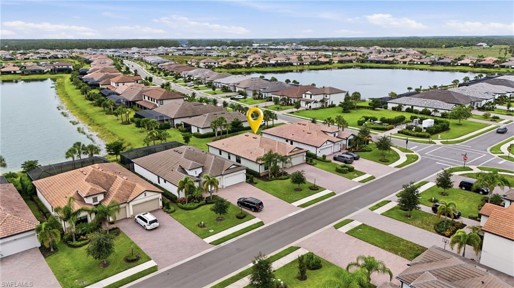 Aerial perspective of a residential community featuring a prominent lake