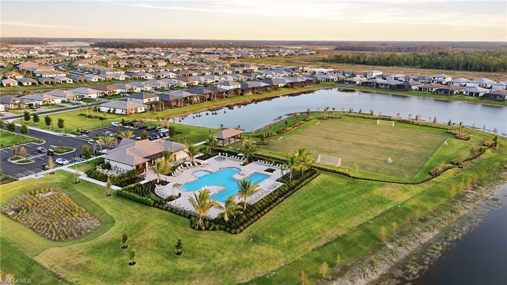 Community amenities featuring a clubhouse, resort-style swimming pool, and an athletic field