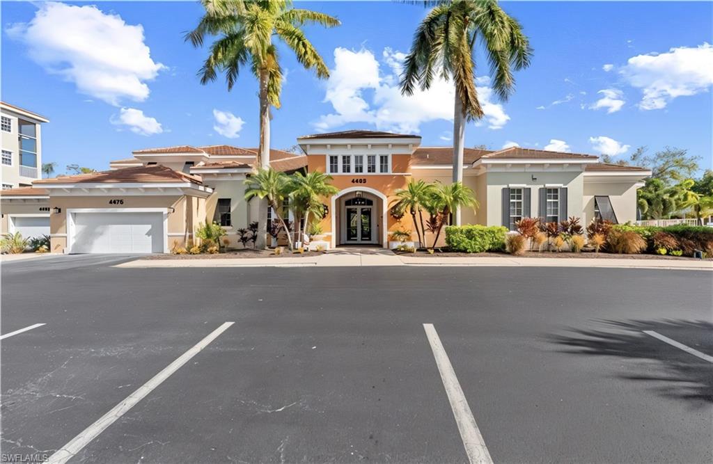 Mediterranean / spanish-style house with french doors, stucco siding, and uncovered parking