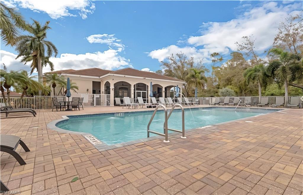 Community pool with a patio
