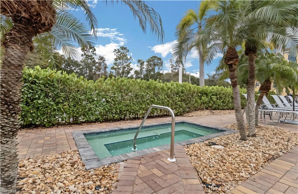 View of pool with a hot tub and a swimming pool
