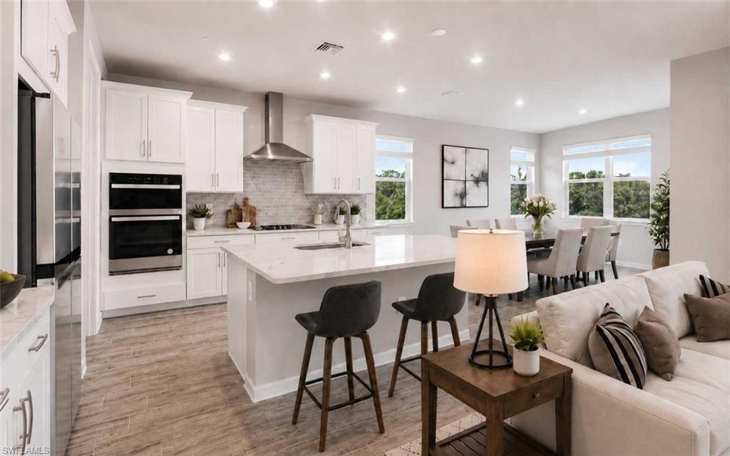 Photo includes reality staging to showcase the possibility of the kitchen/dining/living room. Design services included with purchase!