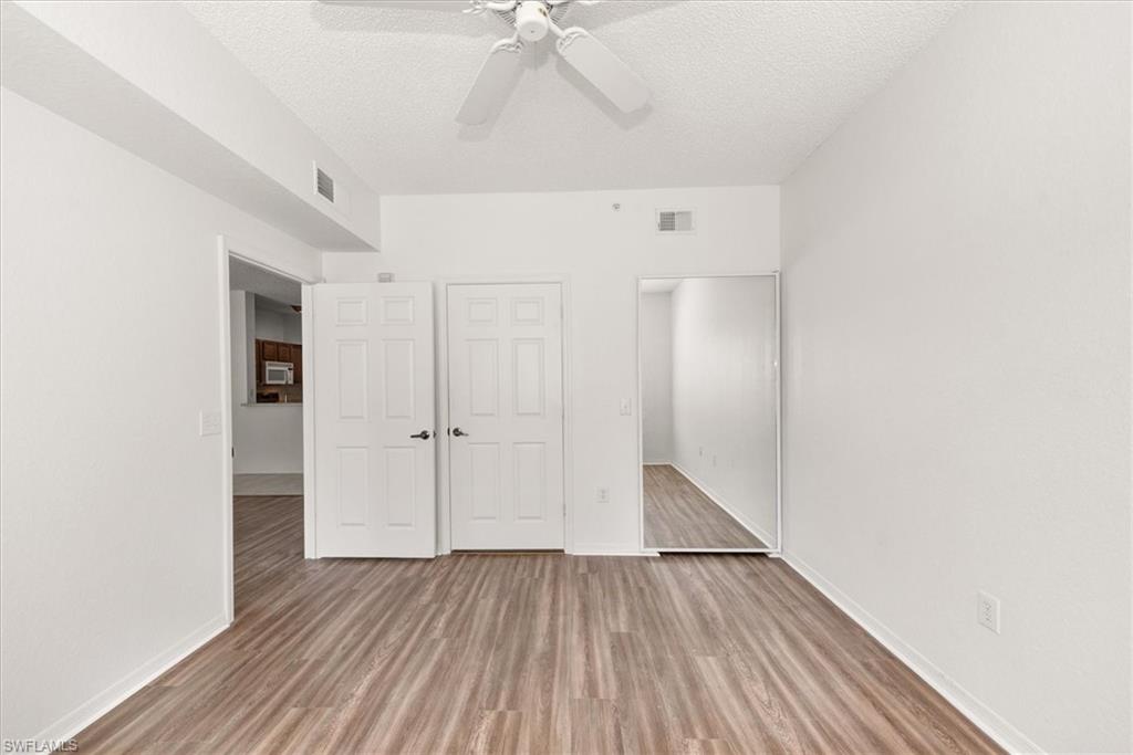 Neutral white walls with wood-finish flooring