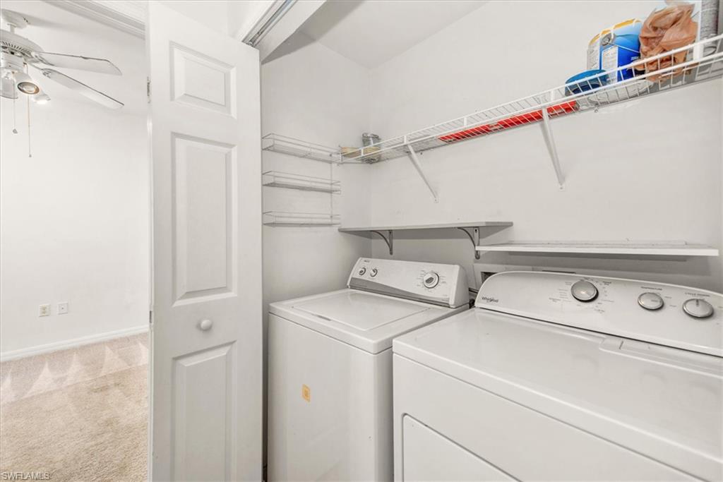Dedicated laundry area featuring a white washer and dryer pair, overhead wire shelving, and two white wall-mounted shelves