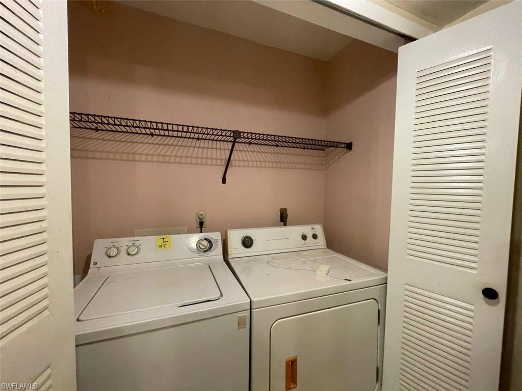 Dedicated laundry area featuring a top-loading washing machine, front-loading dryer, and a wire storage shelf