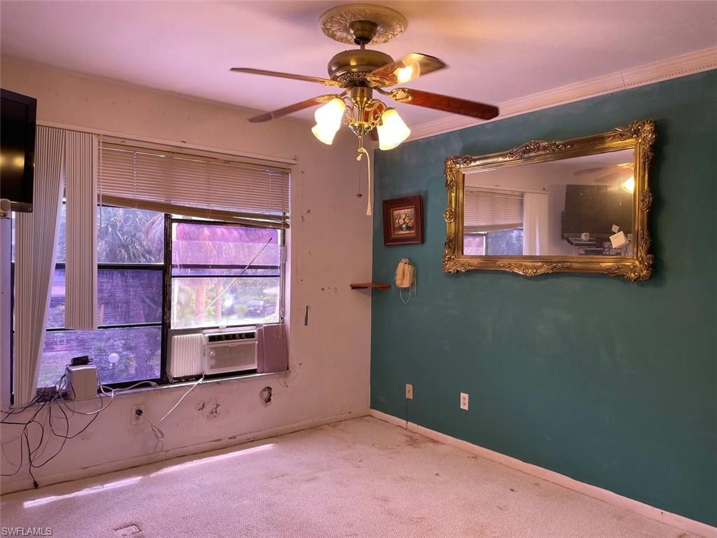 Room featuring a window, ceiling fan, and textured wall accents