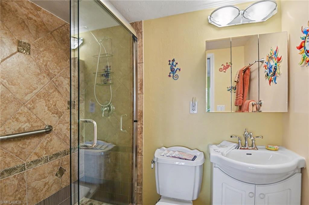 UPDATED GUEST BEDROOM EN-SUITE BATH.  FULL HEIGHT TILED WALK-IN SHOWER W/FRAMELESS GLASS SHOWER DOORS.
