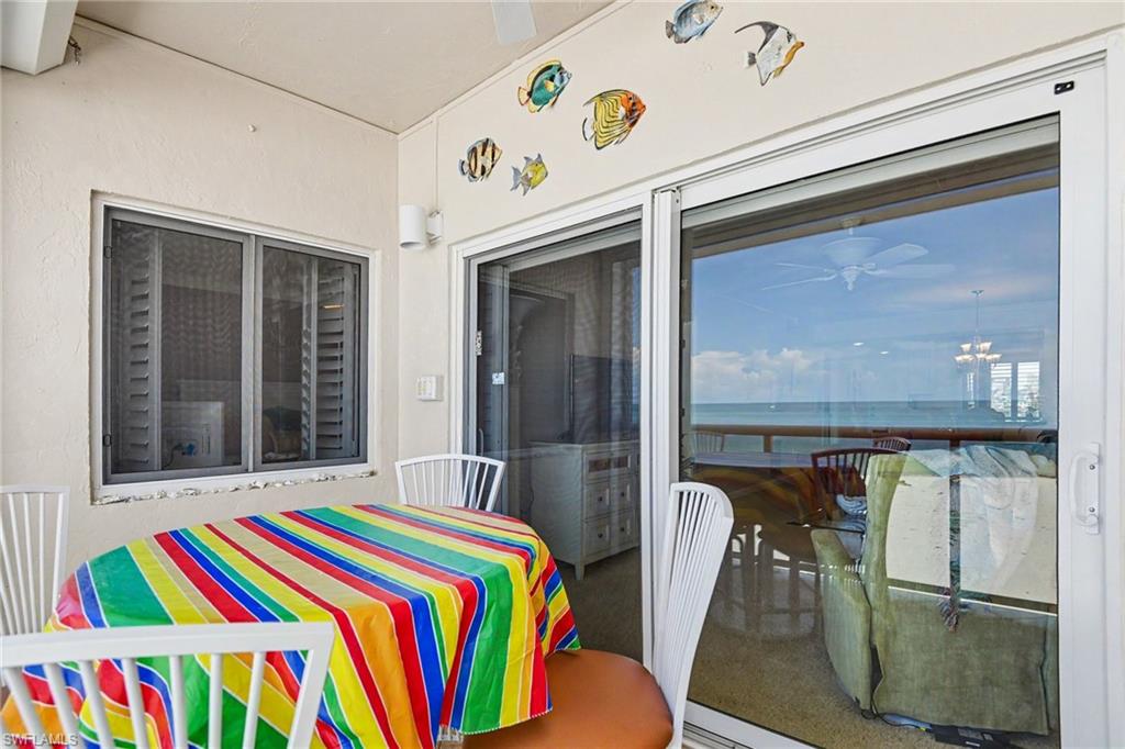 VIEW SHOWING PRIMARY SUITE SOUTHERN WINDOW.  SLIDING DOORS TO LIVING AREA WITH CONVENIENT SCREEN DOOR.  IMPACT RESISTANT WINDOWS AND DOORS.  LANAI ALSO HAS NEW ELECTRIC SHUTTERS.