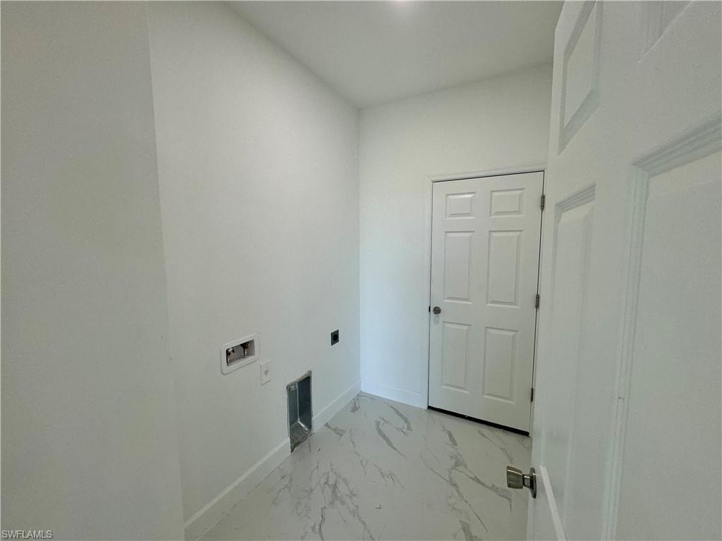 Clothes washing area featuring tile floors, washer hookup, and electric dryer hookup