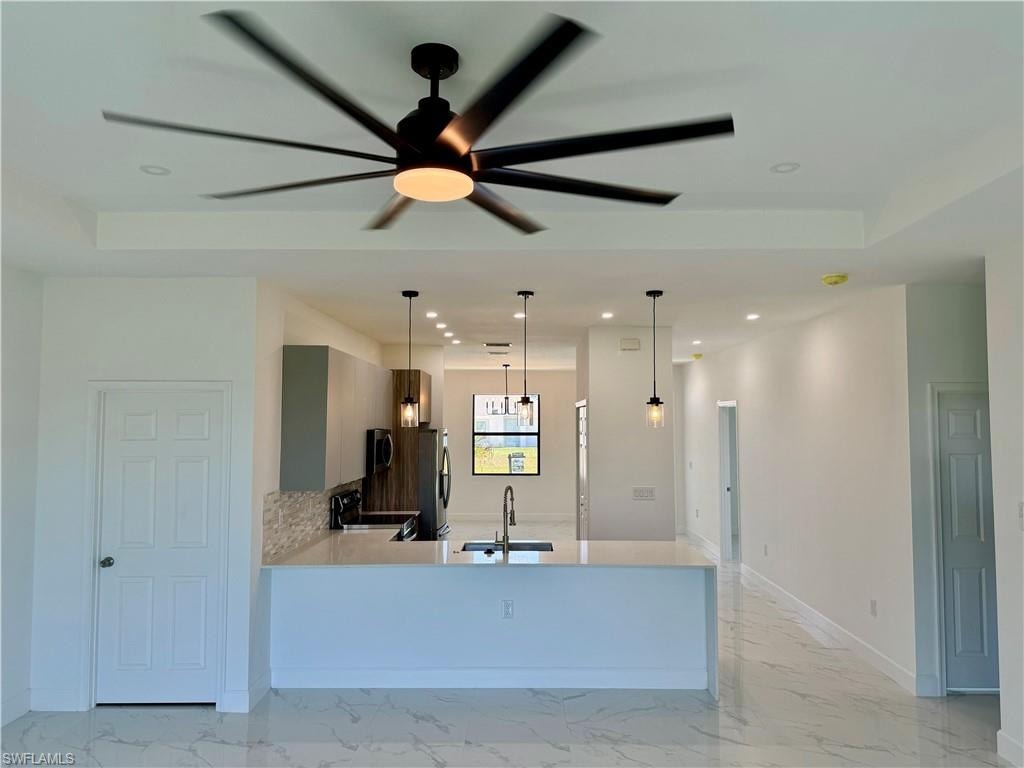 Kitchen featuring stainless steel appliances, light tile flooring, and sink