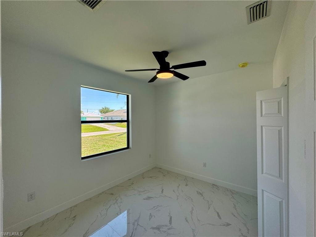 Unfurnished room with tile flooring and ceiling fan