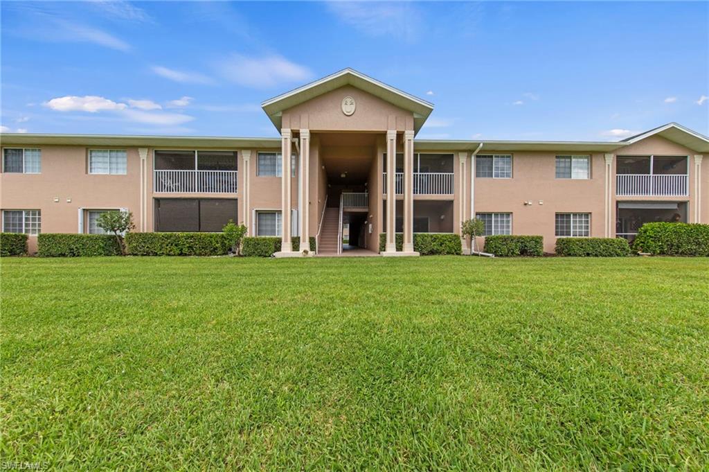 Multi-story residential building featuring a central portico entrance with columns