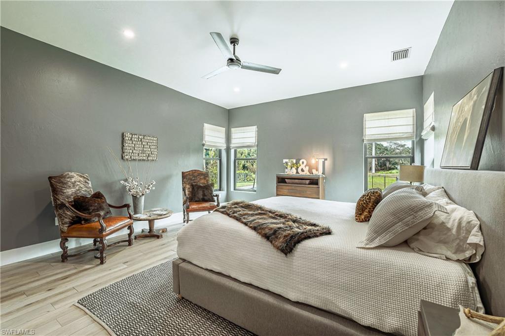 Expansive room featuring wood-finish flooring, recessed lighting, and a contemporary ceiling fan