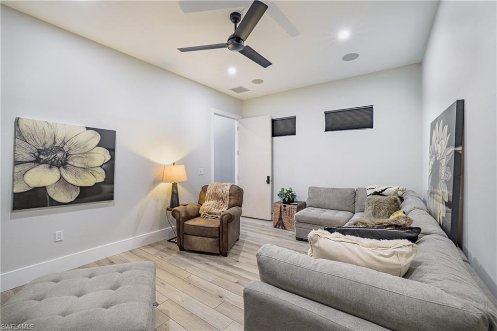 Contemporary living space featuring wood-finish flooring and a neutral color palette