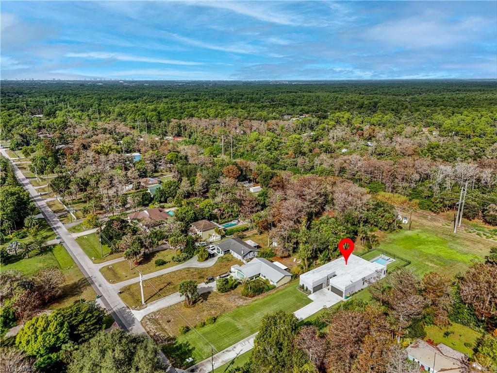 Aerial perspective showcasing a modern single-story residence with a light-colored roof