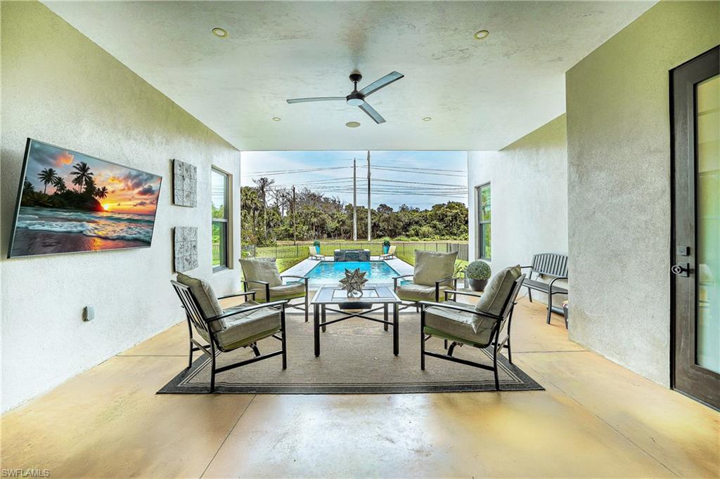 Covered patio with a mounted ceiling fan and recessed lighting