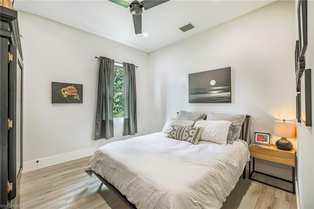 Room featuring light wood-finish flooring, a contemporary ceiling fan, recessed lighting, and white baseboards
