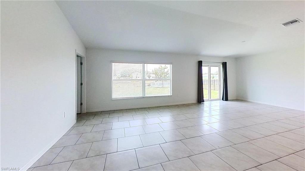 Spacious interior featuring neutral-toned tile flooring throughout