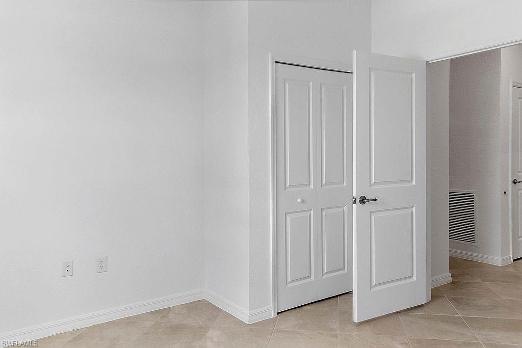 White interior door with brushed nickel hardware, complementing a bi-fold closet door