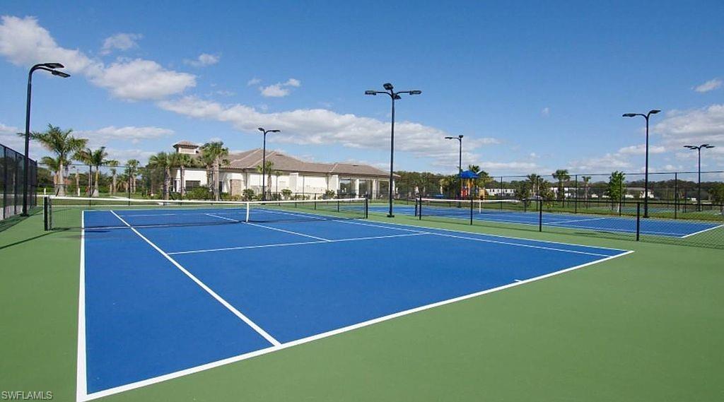 Multiple tennis courts featuring blue and green surfacing
