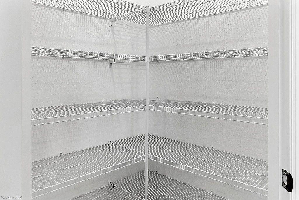 Corner pantry featuring white wire shelving