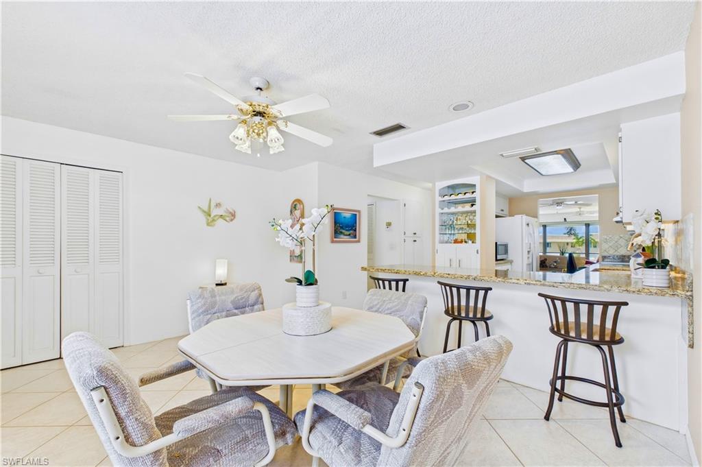 Bright dining area with an open flow to the kitchen and breakfast bar seating
