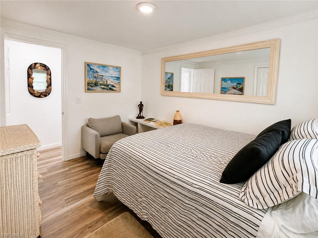 Wood-finish flooring throughout, complemented by white walls and crown molding