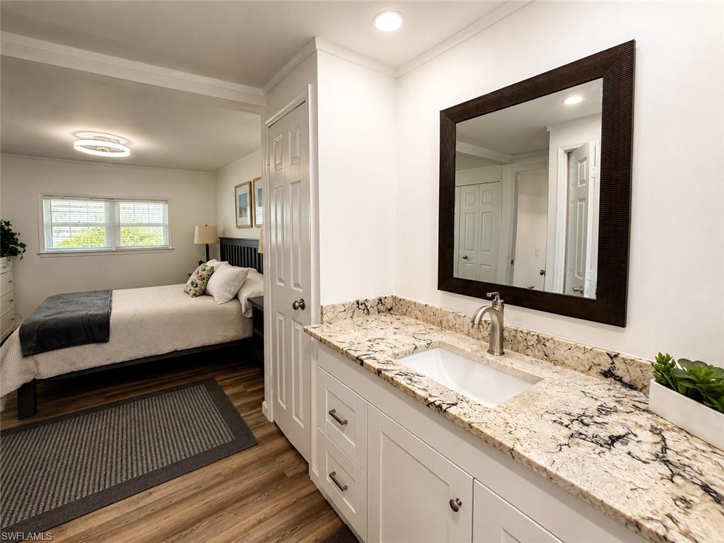 Vanity with granite countertop, undermount sink, and brushed nickel faucet