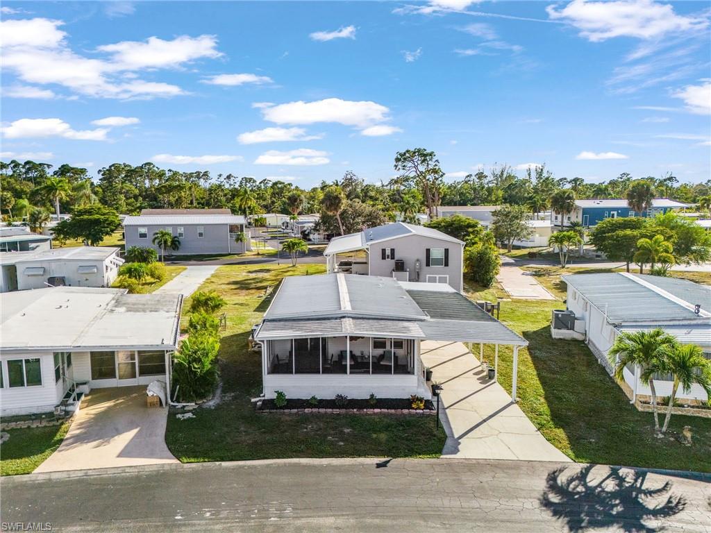 White residence with a car port and screened-in porch