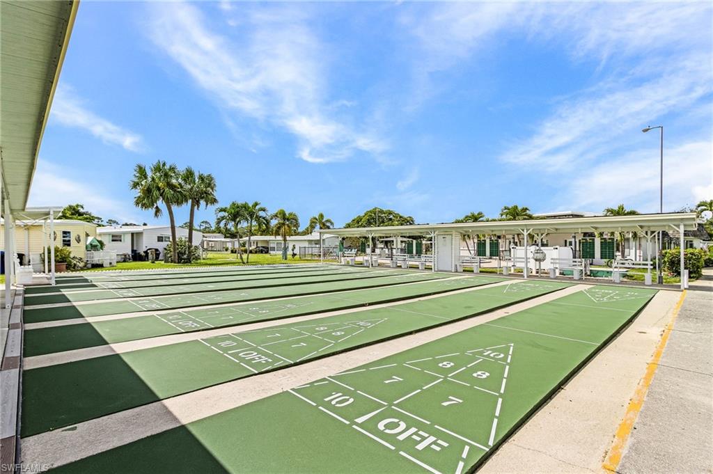 Expansive shuffleboard courts featuring multiple playing lanes and a covered spectator area