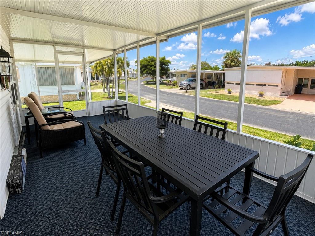 Screened lanai with expansive windows offering natural light and panoramic vistas of the surrounding landscape