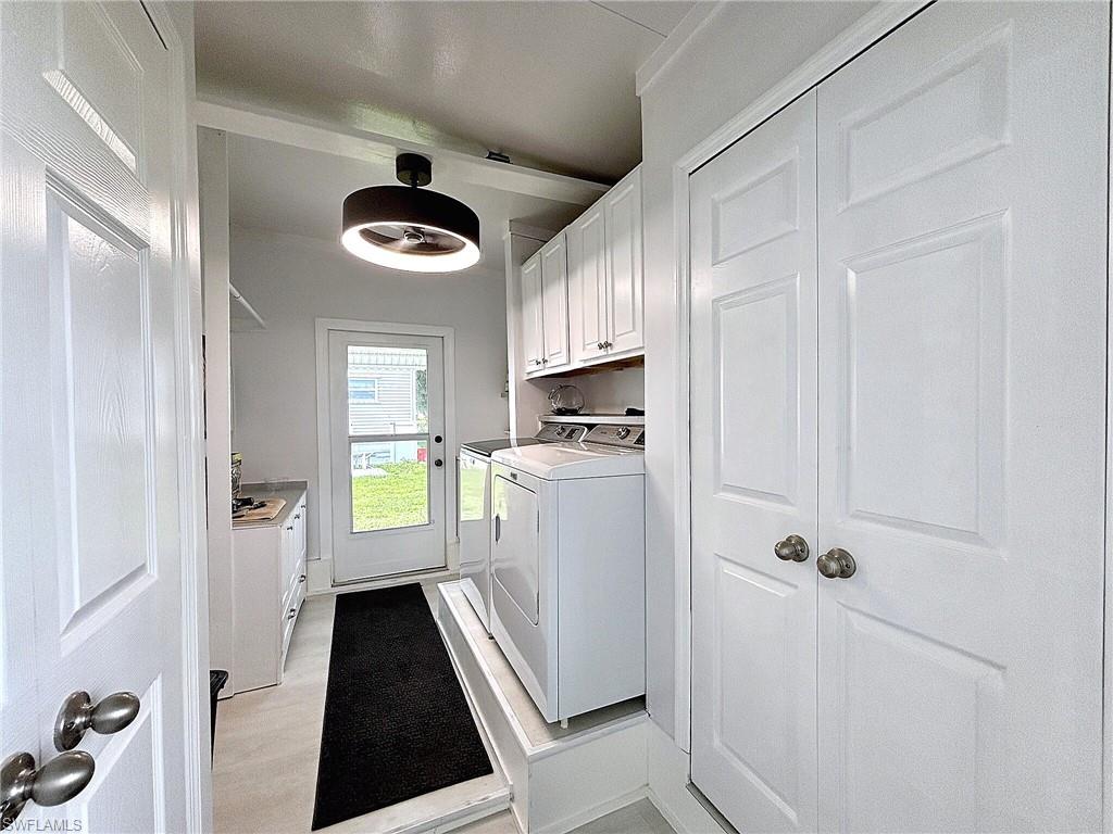 Screened porch with durable flooring, multiple entry points, and exterior lighting fixtures