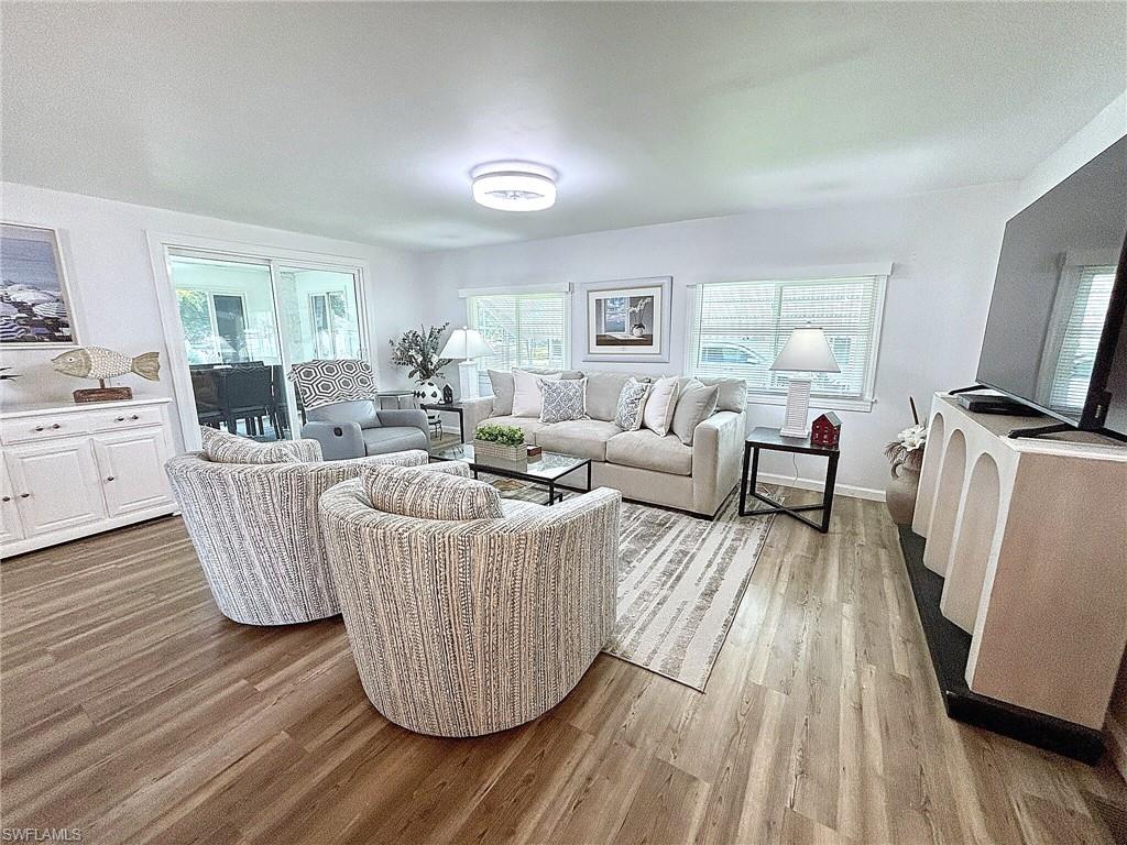 Enclosed sunroom featuring multiple large windows, wall-to-wall carpeting, and a flush-mount ceiling light fixture