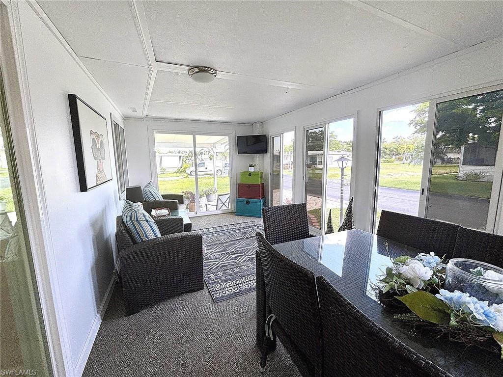 Wall-to-wall carpeting throughout, a window with blinds, and an attached ceiling light fixture