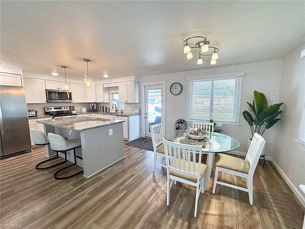Enclosed sunroom featuring multiple sliding glass doors, carpet flooring, a textured white ceiling, and white wall finishes